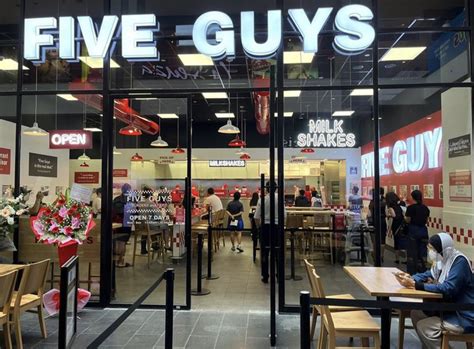 where was the first store built opened overseas five guys